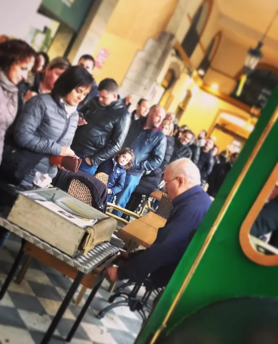En Paco a la parada amb una llarga cua de gent sota les voltes